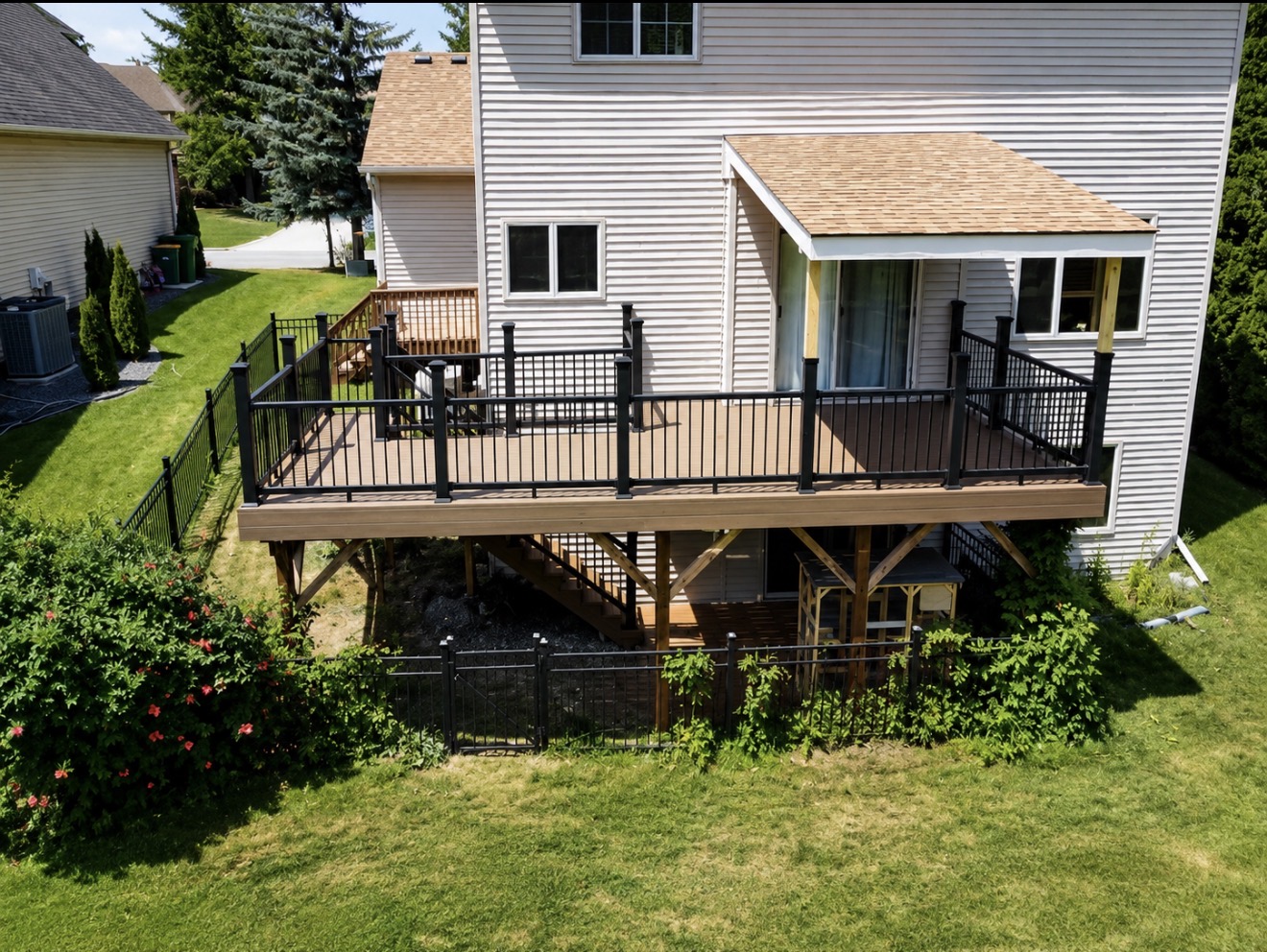 Custom elevated deck with black aluminum railing